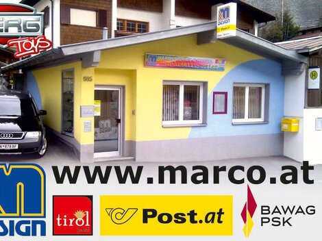 A colorful commercial building with a yellow and blue facade. In front of the building, a black car is parked.